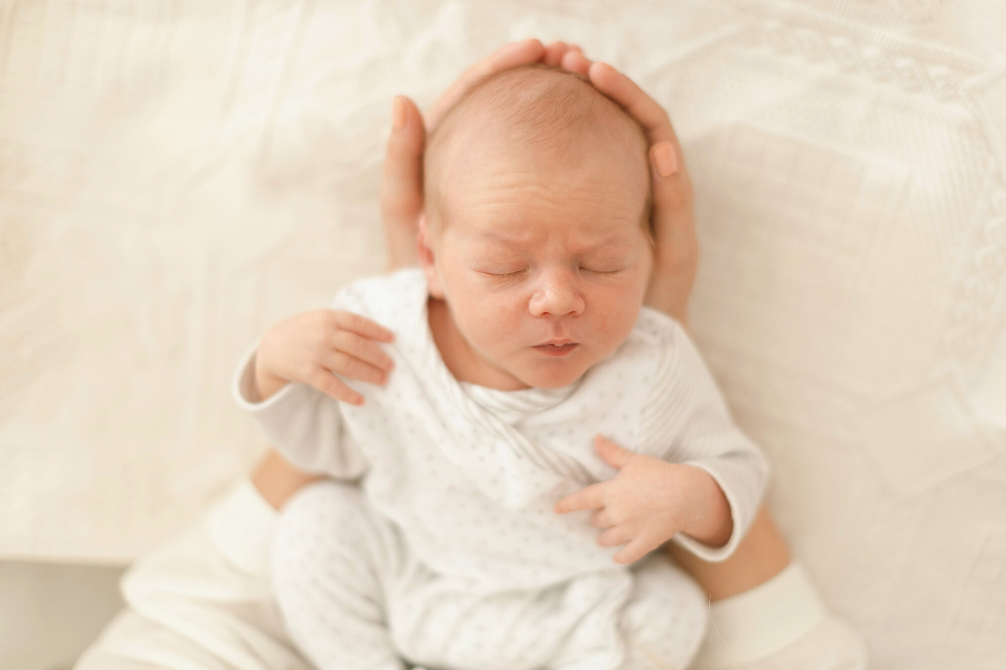 Newborn resting in hands